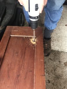 drilling in prep for removing front panel of old pot cupboard