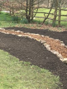 top soil, chippings, stones and grass to create a wildflower garden