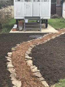 top soil, chippings and stone create wildflower garden with Shepherds Hut