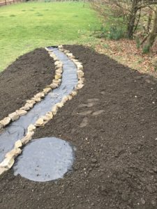 path and topsoil in preparation for wildflower garden