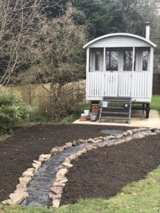 path and topsoil in preparation for wildflower garden with Shepherds Hut