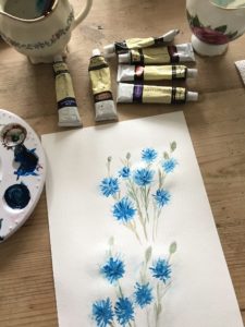 practicing cornflower acrylic painting for homemade signs