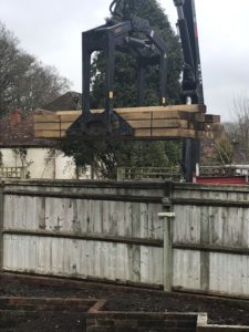 sleepers on forklift lowered into vegetable garden