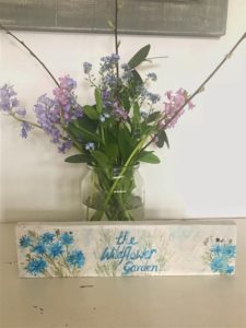 completed homemade signs with bluebells and spring flowers in jam jar