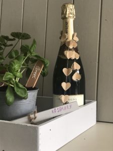 garden tray with champagne basil plant plant markers with paper garland