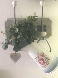 Cath Kidston jugs on hooks with faux eucalyptus