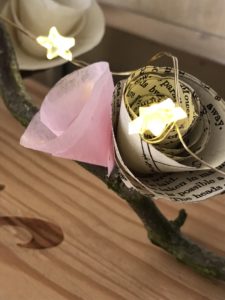 paper roses and fairy lights on wooden box