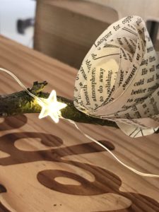 paper roses and fairy lights on wooden box