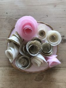 pink plate with various paper roses