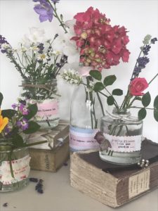 pretty flowers and old books with mini glass jars for diy flower arrangements jar craft