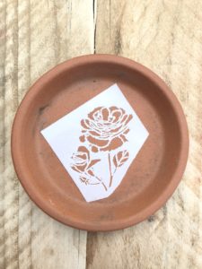 terracotta dish with flower stencil for pot decoration