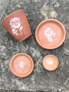 terracotta pots and dishes with flower stencils - pot decoration