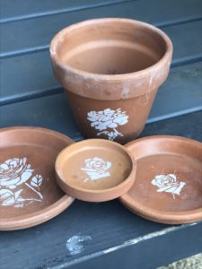 terracotta pots and dishes with flower stencils - pot decoration