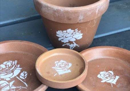 flower stencils on terracotta pots for pot decoration