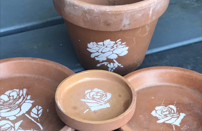 flower stencils on terracotta pots for pot decoration