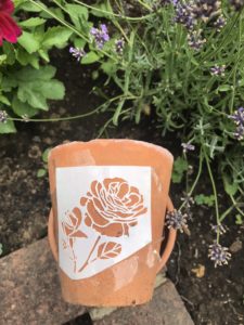 terracotta pot with flower stencil for pot decoration