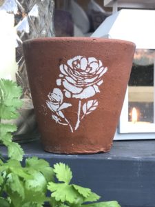 vintage terracotta pot with flower stencil - pot decoration