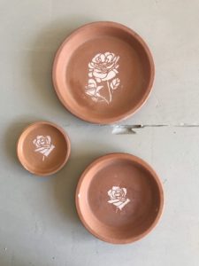 terracotta dishes with flower stencil decoration