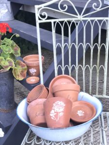 terracotta pots and dishes with flower stencils and word transfers - pot decoration