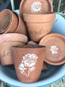 terracotta pots and dishes with flower stencils and word transfers - pot decoration