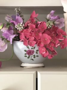 fresh cut flowers create simple flower arrangement in vintage floral pot