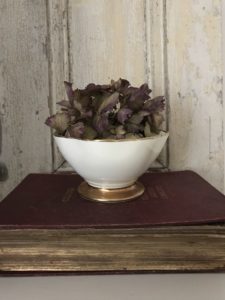 vintage home decor - rustic shutters, old book, bowl and dried hydrangea