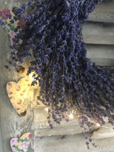 dried lavender wreath, heart garland and lights on rustic shutters create vintage home decor and shabby chic wall decor