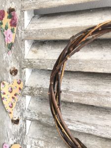 french farmhouse shutters with simple wreath and paper garland create shabby chic wall decor