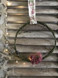 rose and lavender wreaths on rustic shutters with fairy lights and star garland