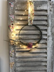 rose and lavender wreaths on rustic shutters with fairy lights and heart garland