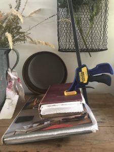 preserving flowers in old books with clamps to use in flower art