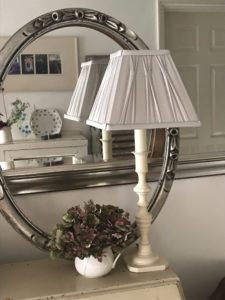 candlestick lamp with grey shade, mirror, silver frame and hydrangea creates home lighting ideas