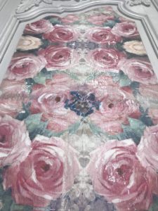 decoupage on wood with floral napkins on white antique armoire door