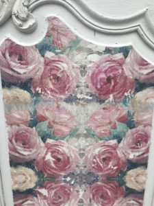 decoupage on wood with floral napkins on white antique armoire door to create shabby chic wall decor