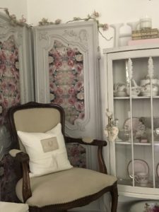 decoupage on wood on antique armoire doors to create shabby chic wall decor with chair and china cabinet