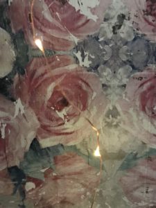 floral decoupage on wood with fairy lights creates shabby chic wall decor