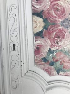 decoupage on wood with floral napkins on white antique armoire door to create shabby chic wall decor