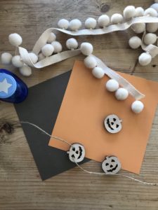 autumn crafts - creating a star garland with pom poms, mini wooden pumpkins and card