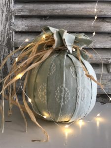 autumn craft - green fabric covered pumpkin with raffia tie and fairy lights for autumn decor