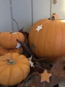 orange pumkins and paper garland create autumn decor