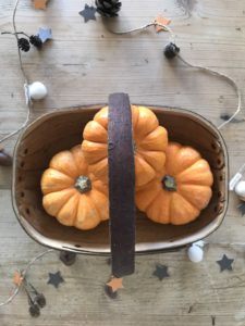 mini orange pumpkins in trug with autumn craft garland create autumn decor