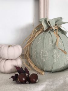 green fabric pumpkin with pink painted pumpkins and seasonal finds creates autumn decor