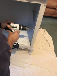 fitting shelf supports inside linen storage cabinet