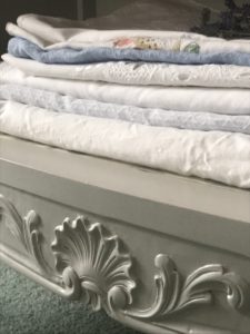 linen storage cabinet detail with tablecloths and linens