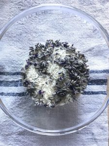 flatlay of lavender and rice mix in glass bowl on grainsack for making theraputic rice bags