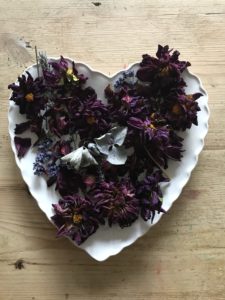 dried purple dahlia heads on heart plate for dried flower crafts