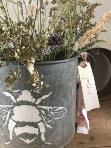 dried flowers used for dried flower crafts in zinc bucket with stenciled bee and label