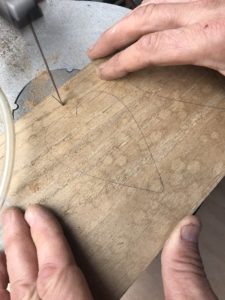 cutting out wooden christmas decorations