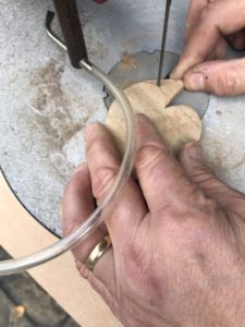 cutting out wooden christmas decorations