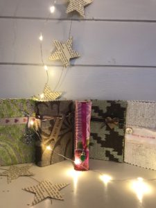 a variety of decorative matchbox covers, lights and paper stars